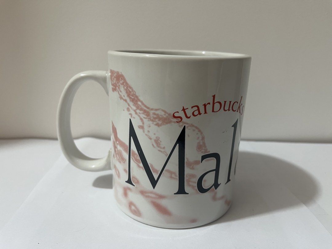 Starbucks Malaysia Mug (Category: Coffee & Tea Tableware) located in Pasig City. Submitted by st_03 (Listing ID 1462798391, Image 1). Description: - Authentic Starbucks mug from Malaysia. - Features a striking red and black marble-like pattern. - 'Malaysia' is clearly visible on the mug. - 'Starbucks' is written vertically on the handle. - Ideal for Starbucks collectors or daily beverage enjoyment. - Used for display only. - Just needs to be wash
