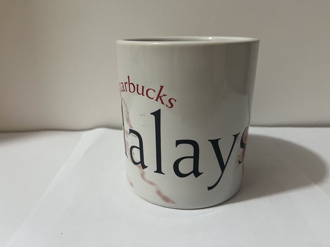 Starbucks Malaysia Mug (Category: Coffee & Tea Tableware) located in Pasig City. Submitted by st_03 (Listing ID 1462798391, Image 2). Description: - Authentic Starbucks mug from Malaysia. - Features a striking red and black marble-like pattern. - 'Malaysia' is clearly visible on the mug. - 'Starbucks' is written vertically on the handle. - Ideal for Starbucks collectors or daily beverage enjoyment. - Used for display only. - Just needs to be wash
