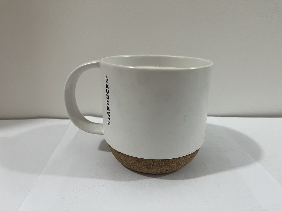Starbucks White Mug with Cork Base (Category: Coffee & Tea Tableware) located in Pasig City. Submitted by st_03 (Listing ID 1462799824, Image 1). Description: - Classic white Starbucks mug - Features a natural cork base - Ideal for your morning coffee or tea - Perfect for Starbucks collectors or everyday use - Used for display only. - Just needs to be washed prior use. .