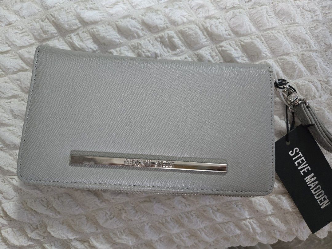 Steve Madden Wallet Wristlet (Category: Wallets & Card holders) located in Manila. Submitted by luxtimeless (Listing ID 1462787378, Image 1). Description: - Grey Steve Madden wallet - Zip-around closure - Detachable wrist strap - Multiple card slots - Clear ID window - Includes original tag.