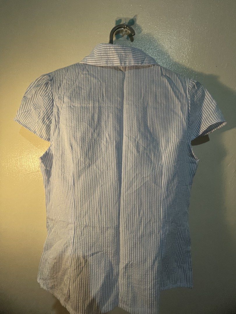 Striped Button-Up Short Sleeve Blouse (Category: Blouses) located in Manila. Submitted by sammmm777 (Listing ID 1462799611, Image 2). Description: - Light blue and white striped blouse - Short sleeves with subtle puff detail - Classic collared neckline with button-up front.