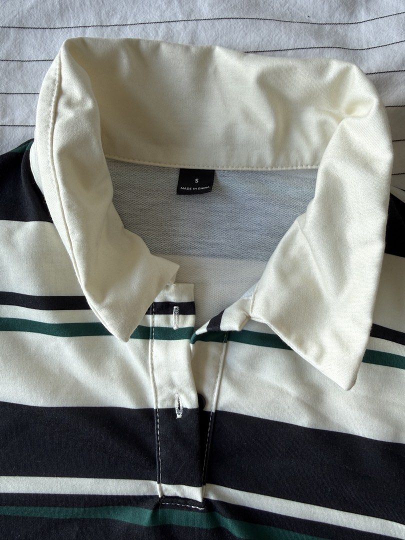 Striped Polo Shirt with Collar (Category: Shirts) located in Taguig. Submitted by liapol2710 (Listing ID 1462711422, Image 2). Description: - Classic black, white, and green striped pattern - Collared neckline with button closure - Long sleeves - Estimated size: Small - Ideal for casual wear.