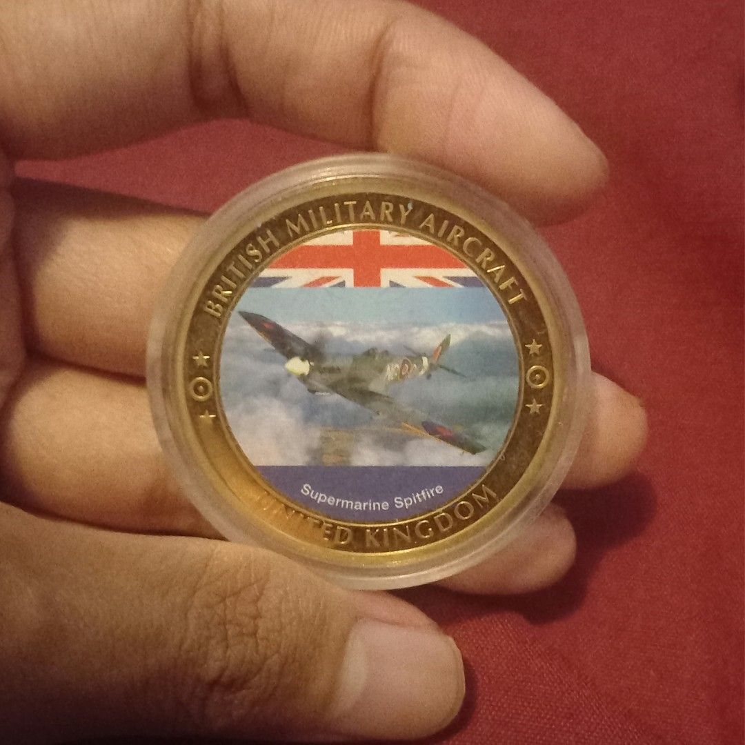 Supermarine Spitfire Commemorative Coin Medallion (Category: Currency) located in Imus. Submitted by mj.trinidad (Listing ID 1462596253, Image 1). Description: 1500. British Military Aircraft Supermarine Spitfire Commemorative Coin Medallion - Commemorative coin featuring the iconic Supermarine Spitfire. - Showcases British military aircraft and the United Kingdom. - One side: Spitfire in flight with the Union Jack. - Other side: Royal emblem (po