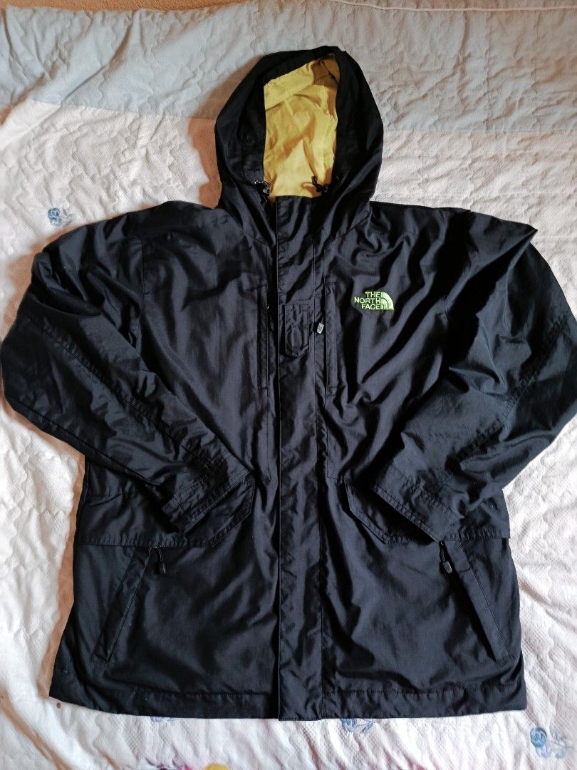 The North Face Black Jacket with Yellow Hood (Category: Coats, Jackets and Outerwear) located in Manila. Submitted by authentic.jaybee (Listing ID 1462728409, Image 1). Description: - Brand: The North Face - Color: Black - Hood Lining: Yellow - Pockets: 2 front zippered pockets, 1 chest zippered pocket - Logo: Subtle logo on the back - Size: Tagged 100 (L) - Ideal for: Outdoor activities.