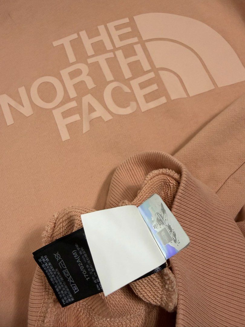 THE NORTH FACE DREW PEAK PULLOVER HOODIE (Category: Coats, Jackets and Outerwear) located in Cavite. Submitted by frankiemnla (Listing ID 1462879025, Image 2). Description: L- 27 W- 22 Size- M to L Design: Features a classic pullover silhouette with a prominent, tone-on-tone screen-printed logo across the chest. Colorway: A muted, earthy pastel shade commonly referred to by the brand as Pink Clay. Functionality: Comes equipped with an adjustable 