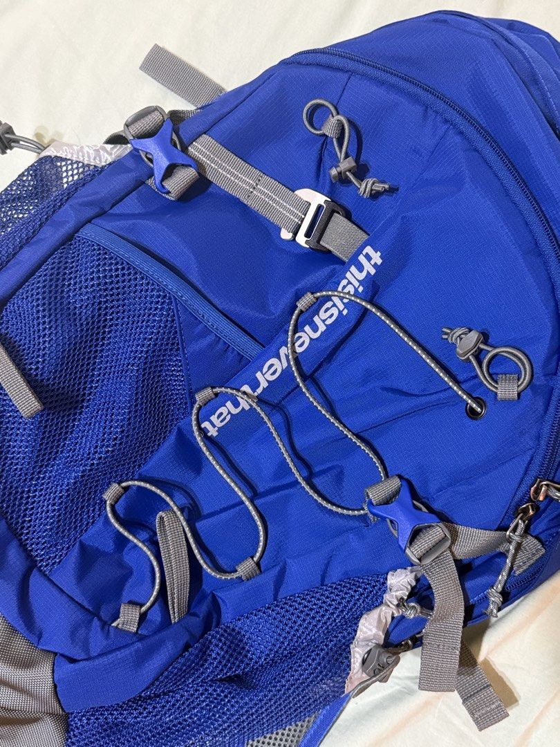 thisisneverthat Backpack (Category: Backpacks) located in Singapore. Submitted by samagksan (Listing ID 1461618060, Image 3). Description: - Brand: thisisneverthat - Color: Blue - Features: Multiple pockets for organization - Side Pockets: Mesh - Front Compartment: Zip closure - Reflective Details: On cords and straps - Ideal for: School, day trips.