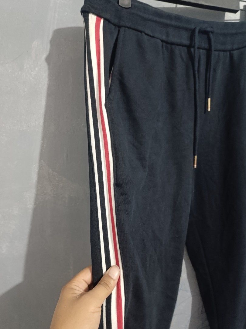 Thom Browne Navy Sweatpants with Tricolor Stripes (Category: Joggers) located in Iloilo. Submitted by wendxcz-thrift- (Listing ID 1462822392, Image 3). Description: - Thom Browne navy sweatpants - Features iconic tricolor stripes down the sides - Comfortable drawstring waist for adjustable fit - Expertly crafted in Japan - Ideal for stylish everyday wear MOP: GCASH/BPI + SF.