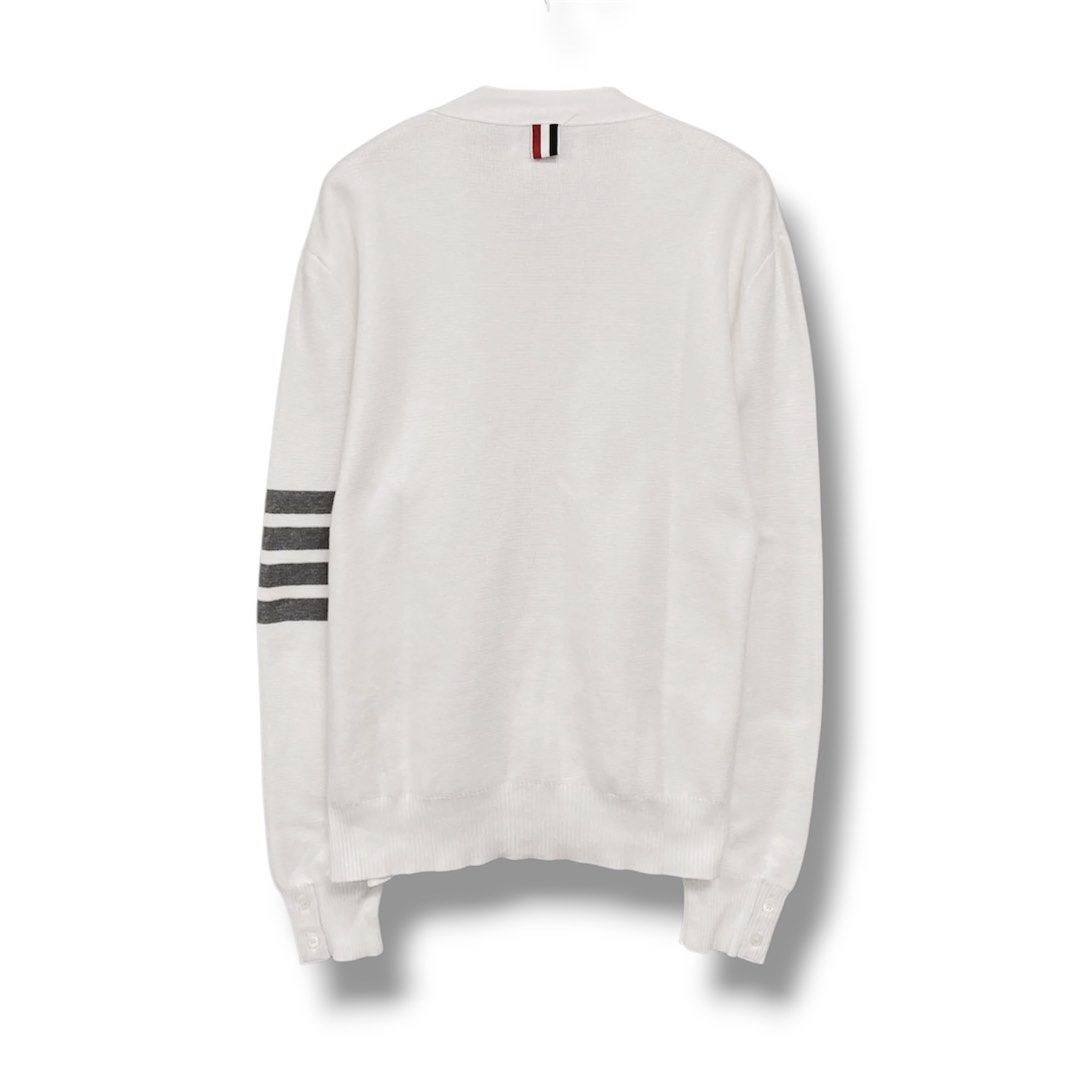 Thom Browne White 4-Bar Stripe Cardigan (Category: Luxury Apparel) located in Cabuyao City. Submitted by 0ld_souls (Listing ID 1462864325, Image 2). Description: - Classic white Thom Browne cardigan - Signature 4-bar stripe detail on left sleeve - Button-up front - Two front pockets - Made in Italy - Ideal for layering.