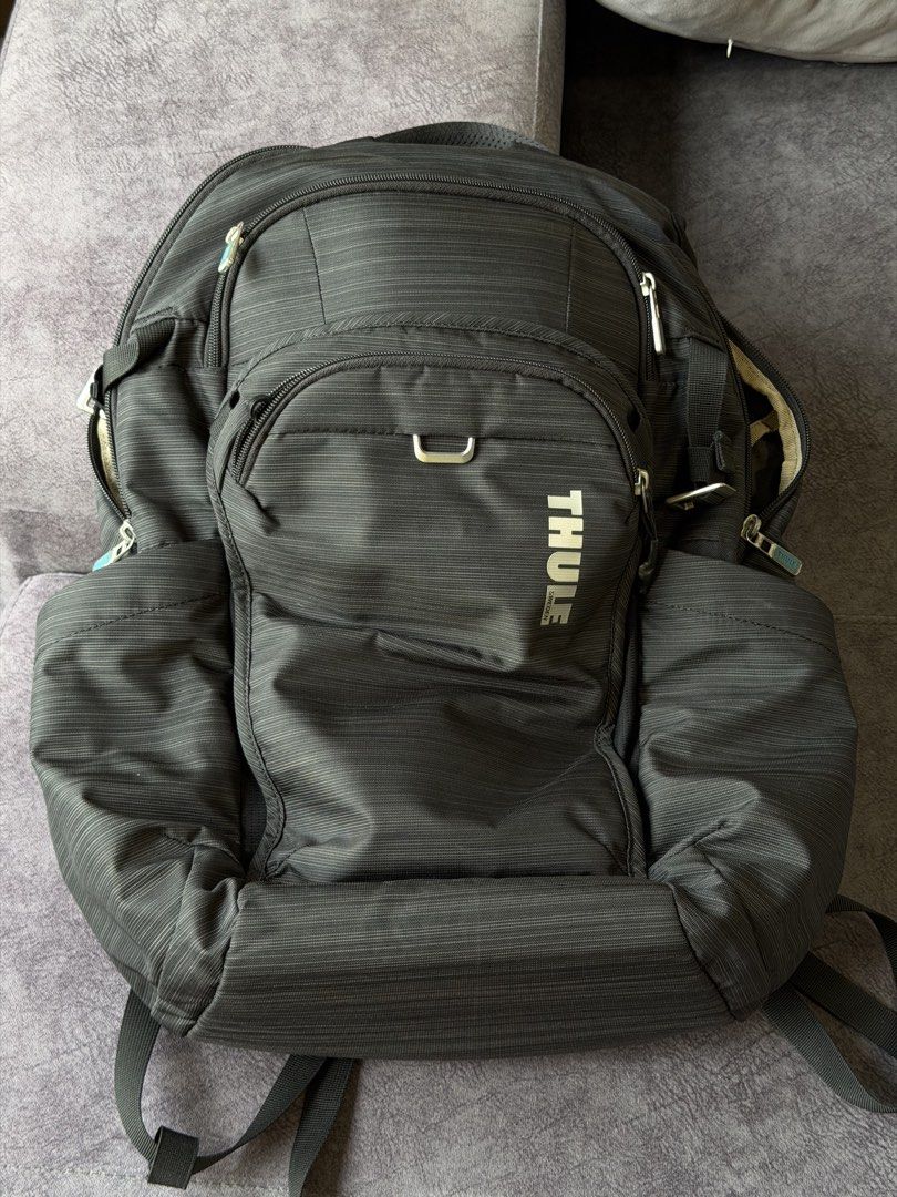 Thule Construct Backpack 24L (Category: Backpacks) located in Singapore. Submitted by leexlss (Listing ID 1462772968, Image 6). Description: • Condition: Well used • 24L capacity • Fits laptop up to 15.6” • Multiple compartments for laptop, tablet & daily essentials • Side pockets for water bottle • Luggage pass-through strap – convenient for travel • Comfortable padded back panel • Durable and practical for everyday use Well used with normal sig