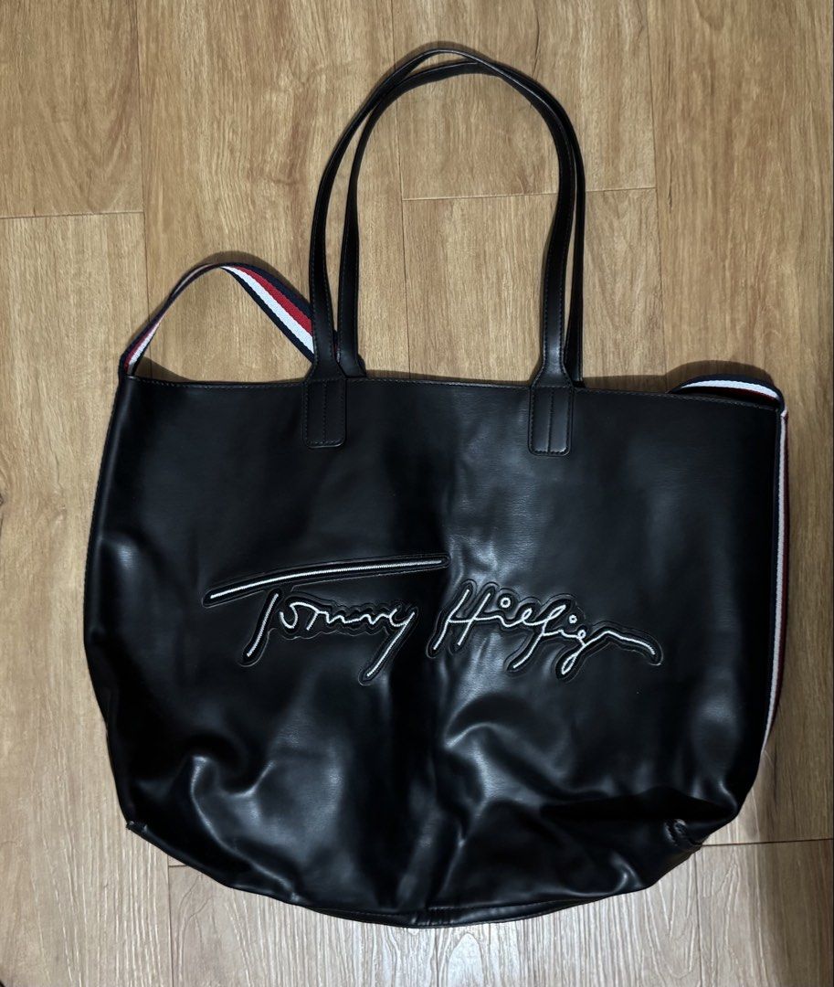 Tommy Hilfiger Black Tote Bag (Category: Tote Bags) located in Manila. Submitted by jrc1994 (Listing ID 1462868834, Image 1). Description: - Large black Tommy Hilfiger tote bag - Perfect for everyday use - Features embroidered signature Tommy Hilfiger logo on the front - Classic red, white, and blue stripe detail on the sides - Handles show some signs of wear -RSF decluttering -LP l000.