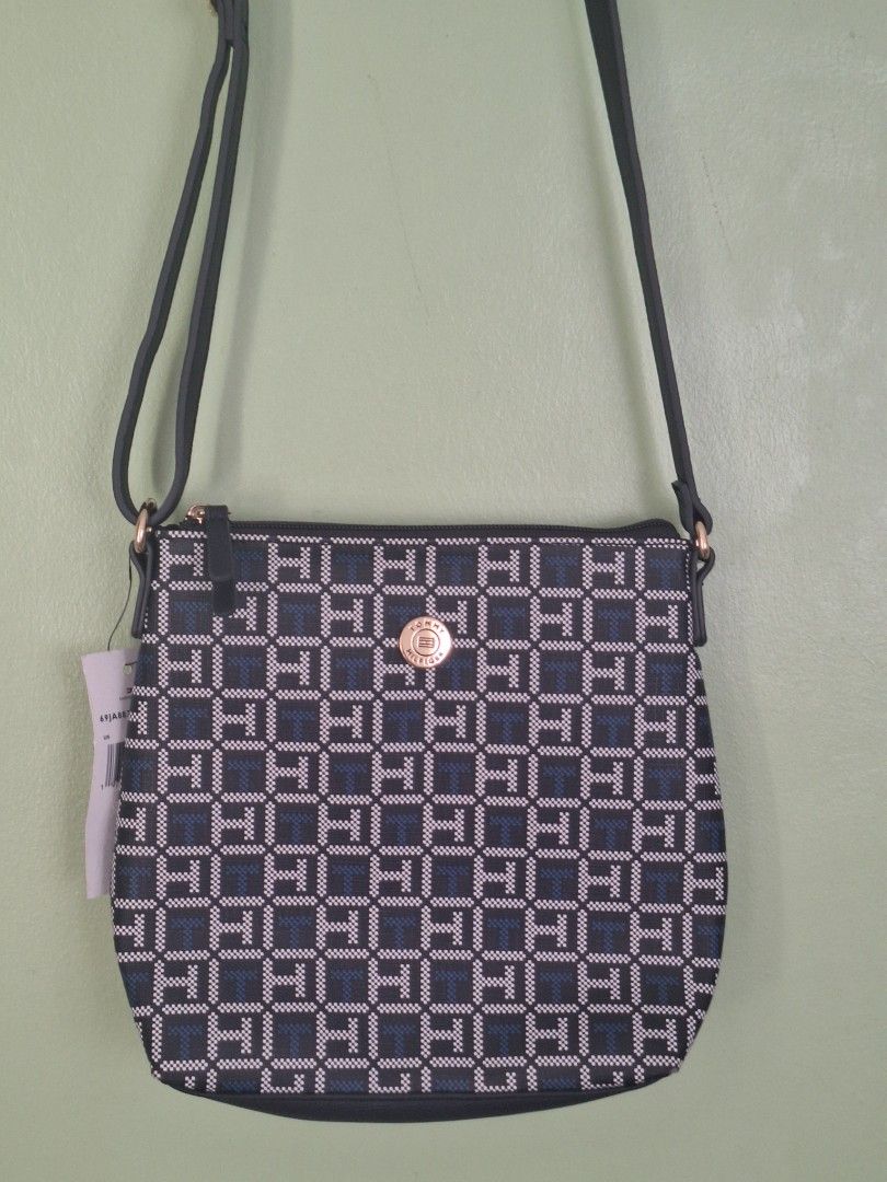 Tommy Hilfiger Monogram Crossbody Bag (Category: Cross-body Bags) located in Quezon City. Submitted by thriftforkeeps (Listing ID 1462752354, Image 1). Description: - Tommy Hilfiger crossbody bag - Navy and white TH monogram pattern - Zipper closure - Adjustable strap - Pasalubong from the US.