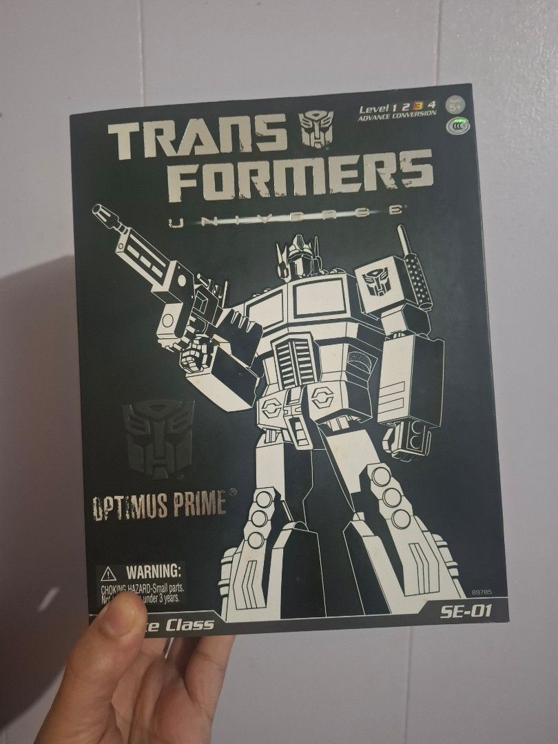 Transformers Universe SE-01 Optimus Prime (Category: Figurines & Statues) located in Las Pinas. Submitted by speedy.caveman30 (Listing ID 1462855327, Image 2). Description: For Sale: Transformers Universe SE-01 Optimus Prime Figure Condition: BIB (Back In Box). Displayed only in robot form. Never transformed. Size: Approx 5.5 in (13.97 cm) Scale: Deluxe Class Box Condition: Yellowing plastic on the window. Dings, scratches and minor crease visibl