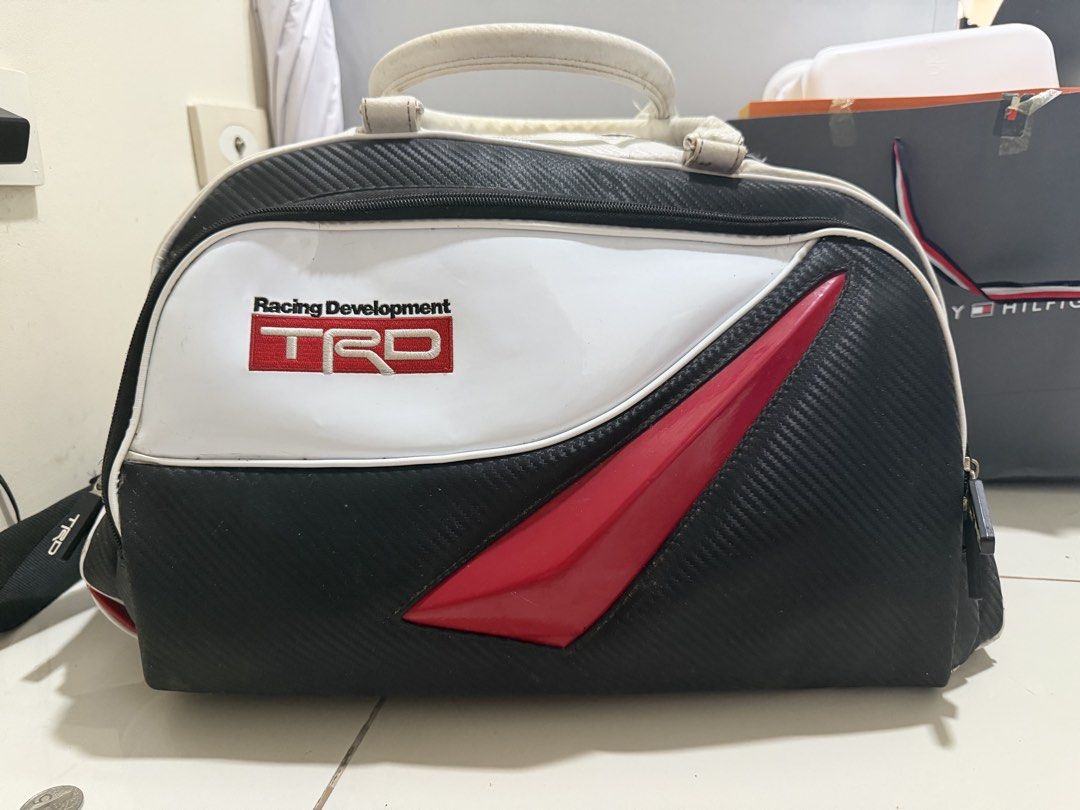 TRD Racing Development Duffel Bag (Category: Luggage) located in Binan City. Submitted by meloo12 (Listing ID 1462766122, Image 1). Description: - TRD duffel bag -Carbon external fabric - White and black design with red trim - Main zipper compartment - Handles - Detachable shoulder strap included - Minor dirt marks on white handles and body - Zippers and strap hardware are intact Listed in the market for $250 but still negotiable. Rfs: declutteri