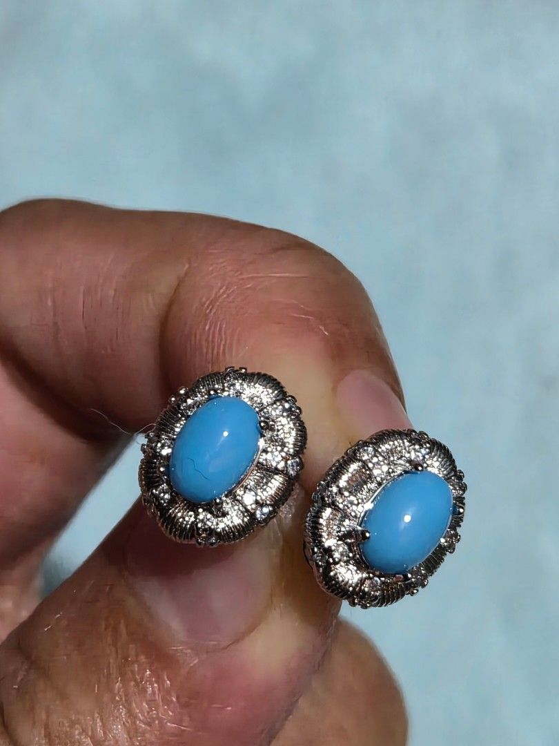 Turquoise Stud Earrings with Silver Setting (Category: Earrings) located in Mandaue City. Submitted by chuchi152615 (Listing ID 1462826906, Image 2). Description: - Cute oval turquoise stud earrings - Set in textured silver-tone metal - Features small stones around the edge - Secure stud backs for comfortable wear - Adds a pop of color to any outfit - Ideal for everyday wear or dressing up.