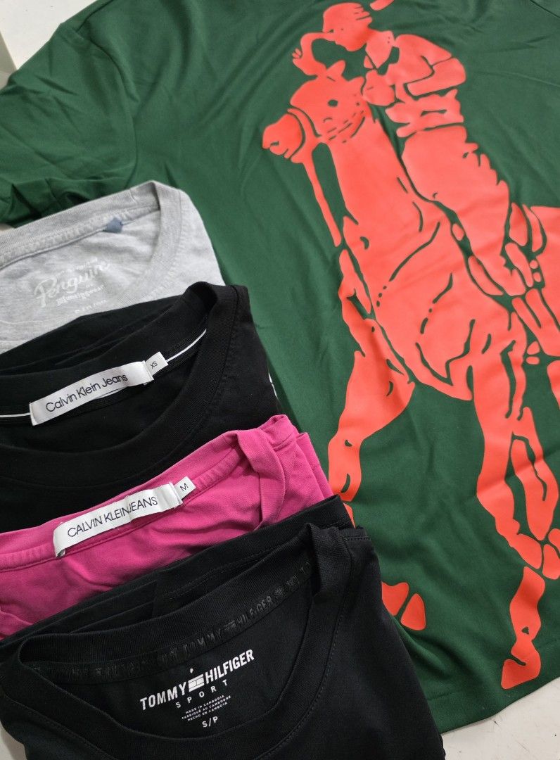 Used clothes for sale (Category: Tshirts & Polo Shirts ) located in San Fernando. Submitted by luckydog.0d4b76 (Listing ID 1462722714, Image 2). Description: Selling a mix of branded tops. Includes Lacoste, Penguin, Calvin Klein Jeans, and Tommy Hilfiger Sport. Various colours and sizes. Some are polo shirts, others are t-shirts. Great for casual wear. Check photos for details on each piece. Bundle deal available..
