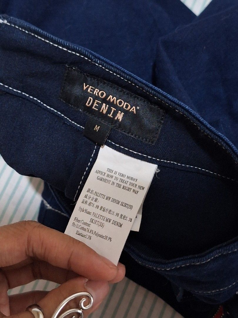 Vero Moda Denim Wrap Skirt Size M (Category: Skirts) located in Taguig. Submitted by butterflypea.thrift (Listing ID 1462852599, Image 3). Description: - Vero Moda dark wash denim wrap skirt - Size: waist - 28 , length - 15 - Features a side tie detail - Red and blue stripe accent on tie - Material: Cotton with stretch - Ideal for casual outfits.