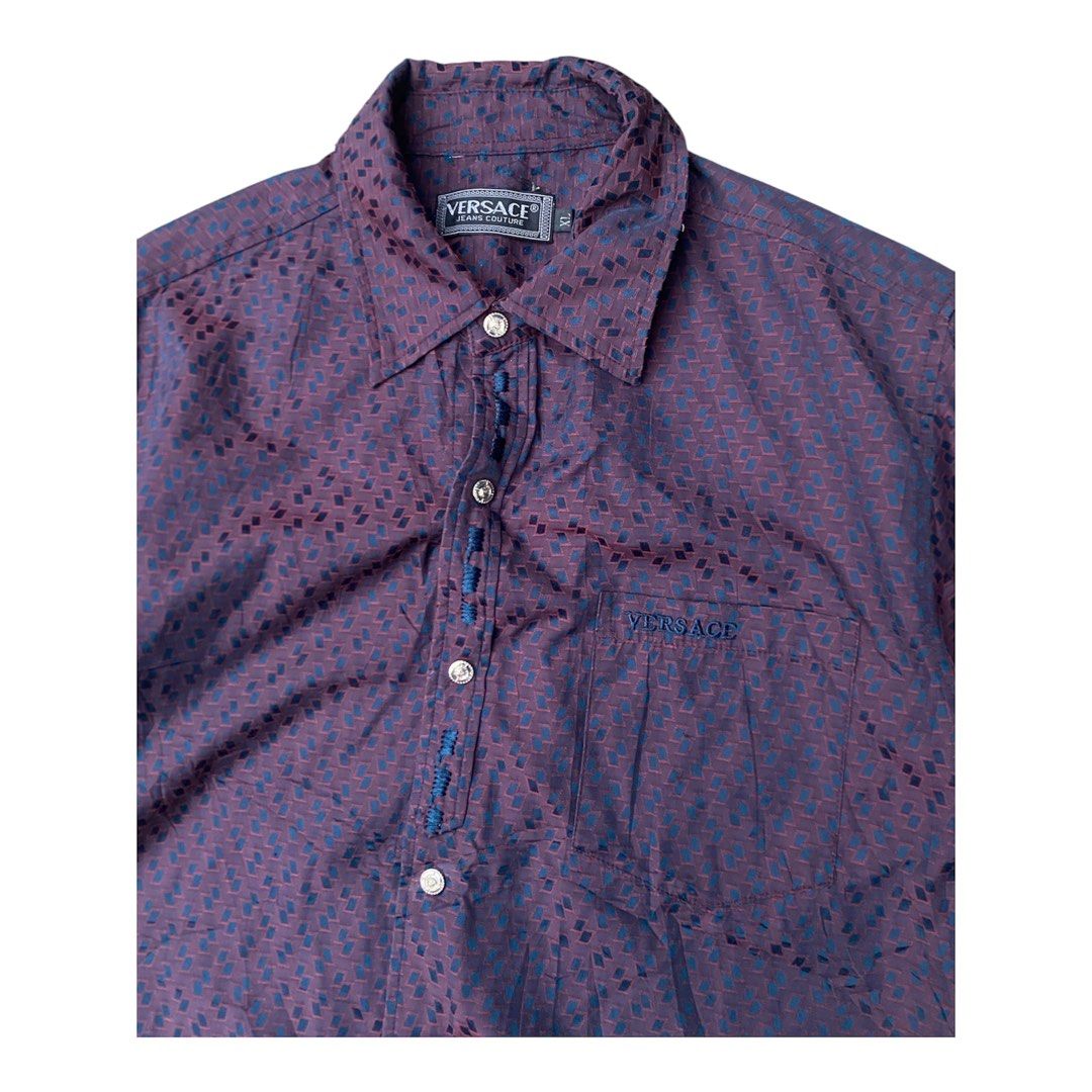 Versace Short Sleeve Button Up Shirt (Category: Tshirts & Polo Shirts ) located in Bacolod City. Submitted by unkemptrags (Listing ID 1462844649, Image 2). Description: - Versace Short Sleeve Button down - Color: Burgundy with Dark Blue Geometric Pattern - w21.5 l28.5 - Features: Chest Pocket, Button Closure - Origin: Made in Italy - Style: Ideal for Night Out or Casual Wear.