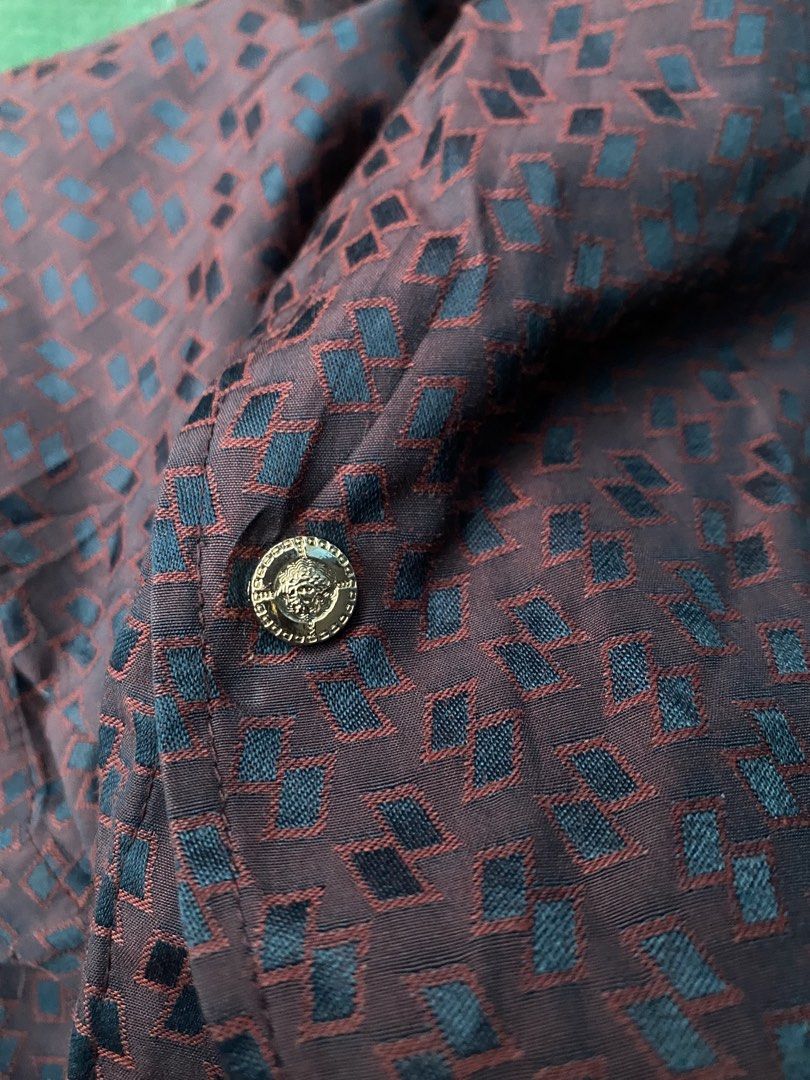 Versace Short Sleeve Button Up Shirt (Category: Tshirts & Polo Shirts ) located in Bacolod City. Submitted by unkemptrags (Listing ID 1462844649, Image 3). Description: - Versace Short Sleeve Button down - Color: Burgundy with Dark Blue Geometric Pattern - w21.5 l28.5 - Features: Chest Pocket, Button Closure - Origin: Made in Italy - Style: Ideal for Night Out or Casual Wear.