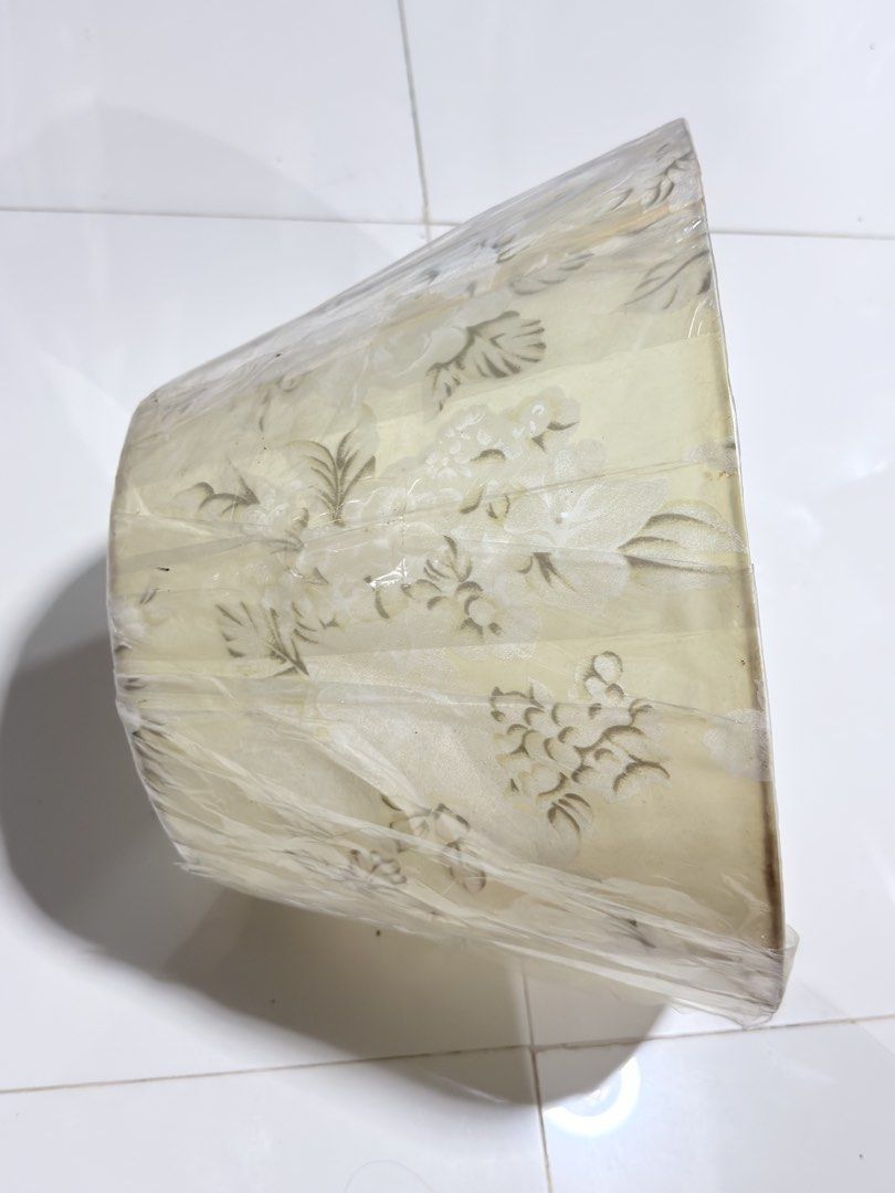 Vintage Floral Lampshade (Category: Lighting) located in Paranaque City. Submitted by thousandfold (Listing ID 1462695457, Image 3). Description: Sale swap to catfood for strays - Cream-colored lampshade with a delicate floral pattern. - Slightly textured fabric finish. - Standard fitting, suitable for table or floor lamps. - Approximate dimensions: 8 inches height, 10 inches diameter. - Adds a classic touch to any room..