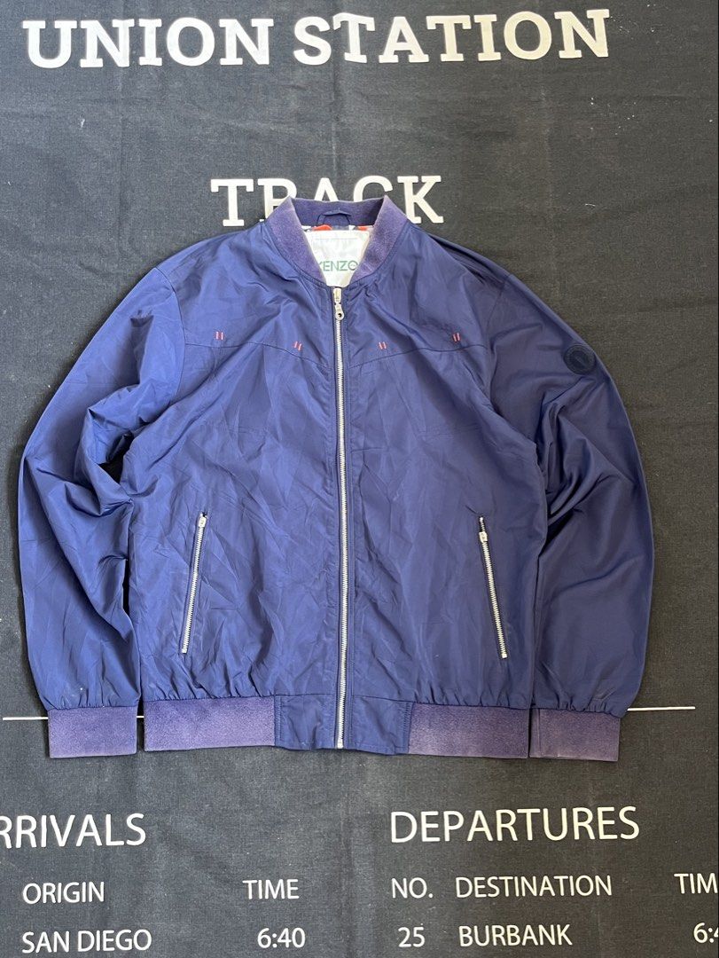 Vintage Kenzo Blue Bomber Jacket (Category: Coats, Jackets and Outerwear) located in San Pedro. Submitted by lewisbadinas06 (Listing ID 1462694919, Image 1). Description: Kenzo Bomber Jacket 22W 27L Issue Pocket Zipper (Handles only still working) Ribbings Color Fading Color Rate 7/10.