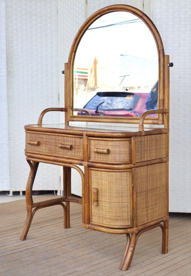 Vintage Rattan Vanity Table with Mirror (Category: Tables & Sets) located in Bulacan. Submitted by FurnitureGallery (Listing ID 1462833751, Image 2). Description: - Vintage rattan vanity table - Large, adjustable arched mirror - Two drawers on top for storage - Cabinet below for additional space - Intricate rattan weave - Creates a natural, bohemian aesthetic - Ideal for bedrooms or dressing areas JAPAN SURPLUS FURNITURE RATTAN VANITY DRESSER Siz