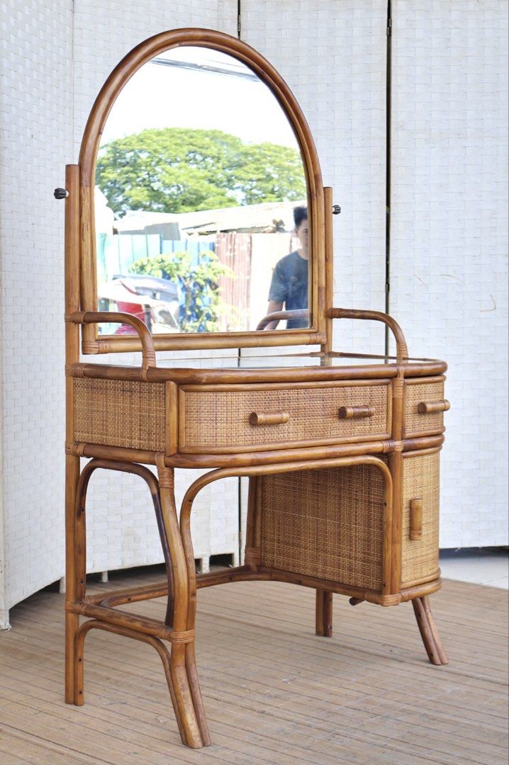 Vintage Rattan Vanity Table with Mirror (Category: Tables & Sets) located in Bulacan. Submitted by FurnitureGallery (Listing ID 1462833751, Image 3). Description: - Vintage rattan vanity table - Large, adjustable arched mirror - Two drawers on top for storage - Cabinet below for additional space - Intricate rattan weave - Creates a natural, bohemian aesthetic - Ideal for bedrooms or dressing areas JAPAN SURPLUS FURNITURE RATTAN VANITY DRESSER Siz