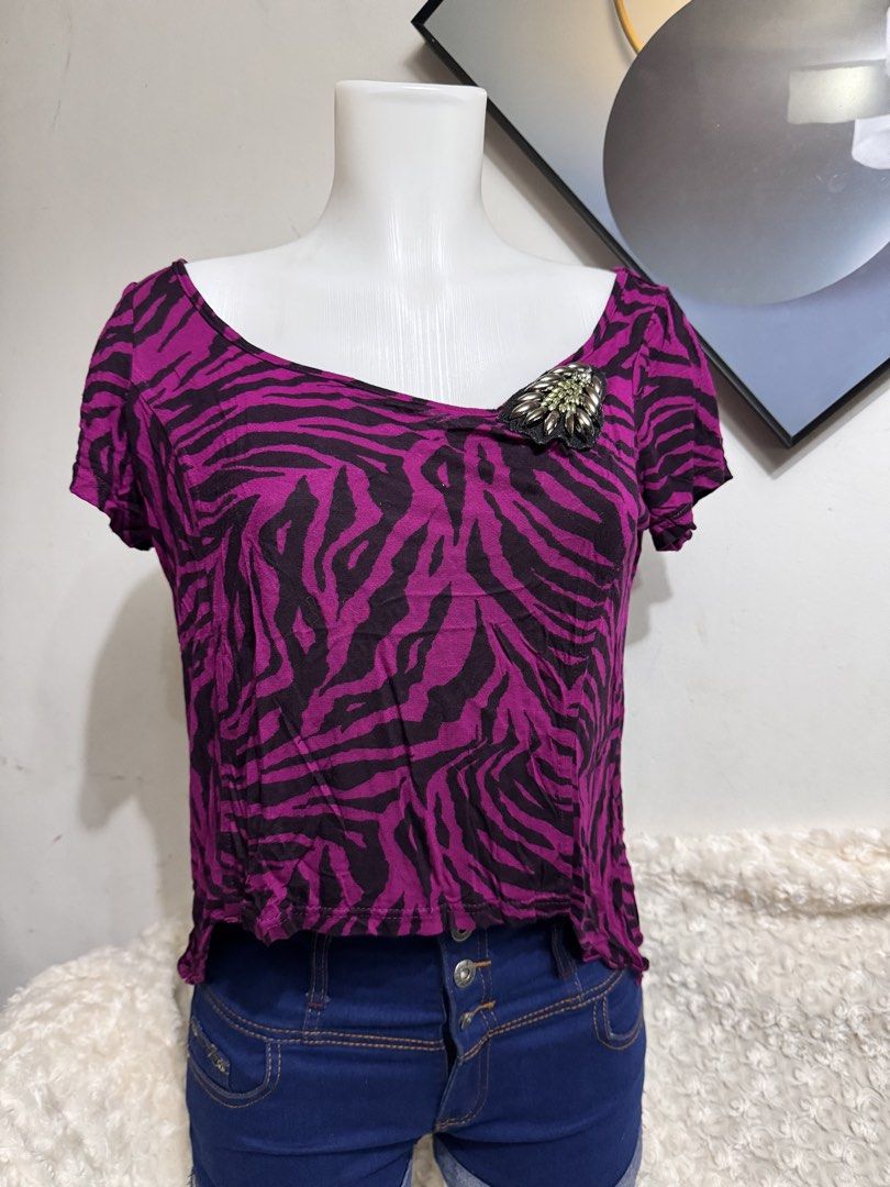 Vivid Zebra Print Top L-XL (Category: Blouses) located in Marikina City. Submitted by lorradel (Listing ID 1462705988, Image 1). Description: - fits L-XL - Eye-catching purple and black zebra print - Comfortable short sleeves - Flattering scoop neckline - Adorable decorative brooch detail near the shoulder - Slightly ruffled hem for a playful touch - Ideal for a stylish casual outfit - MAY HAVE some washable stains (hindi maiiwasan) needs washing