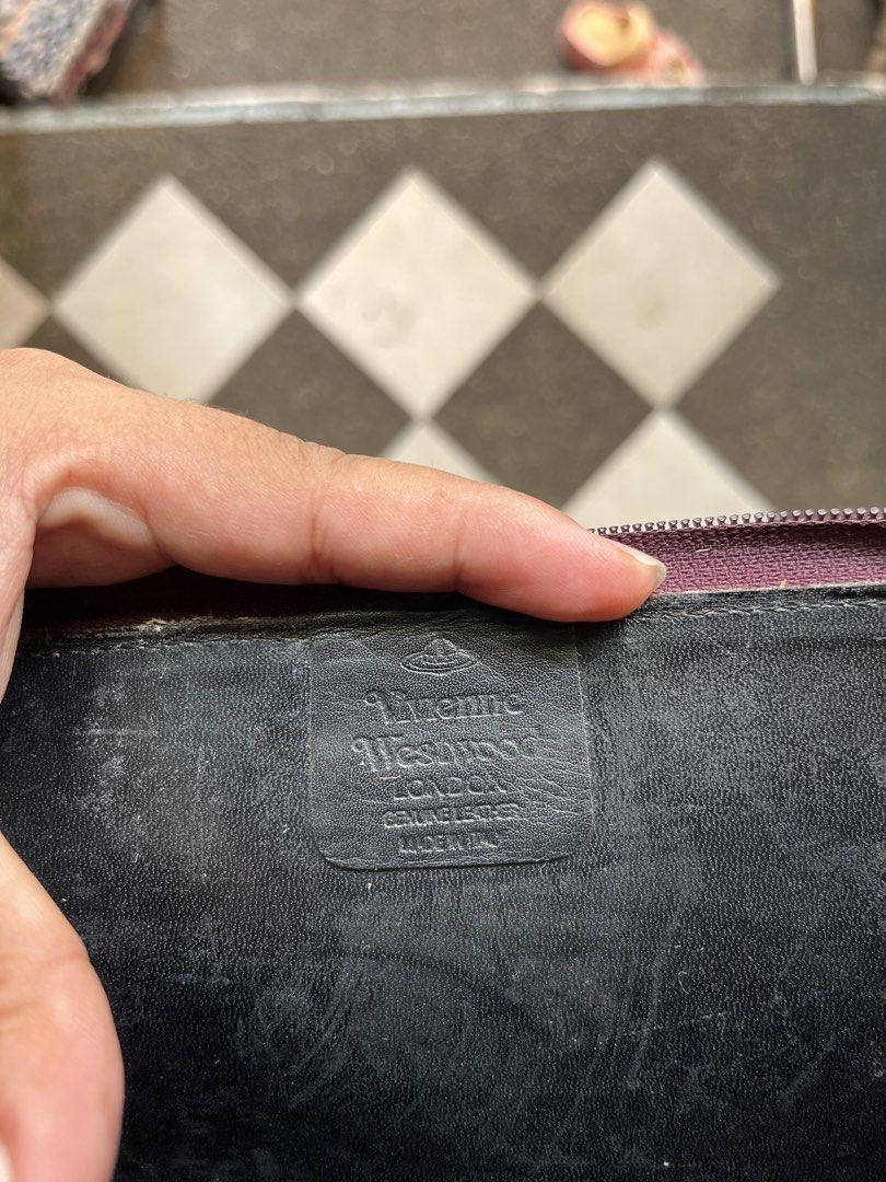 Vivienne Westwood Leather Orb Pattern Zip Around Wallet (Category: Luxury Bags & Wallets) located in Tabuk. Submitted by collectors_thrift_shop (Listing ID 1462706469, Image 3). Description: - Authentic Vivienne Westwood wallet - Genuine leather with iconic orb pattern - Zip-around closure for security - Multiple card slots and compartments for organization - Made in Italy - Shows some signs of wear on interior and exterior, consistent with regul