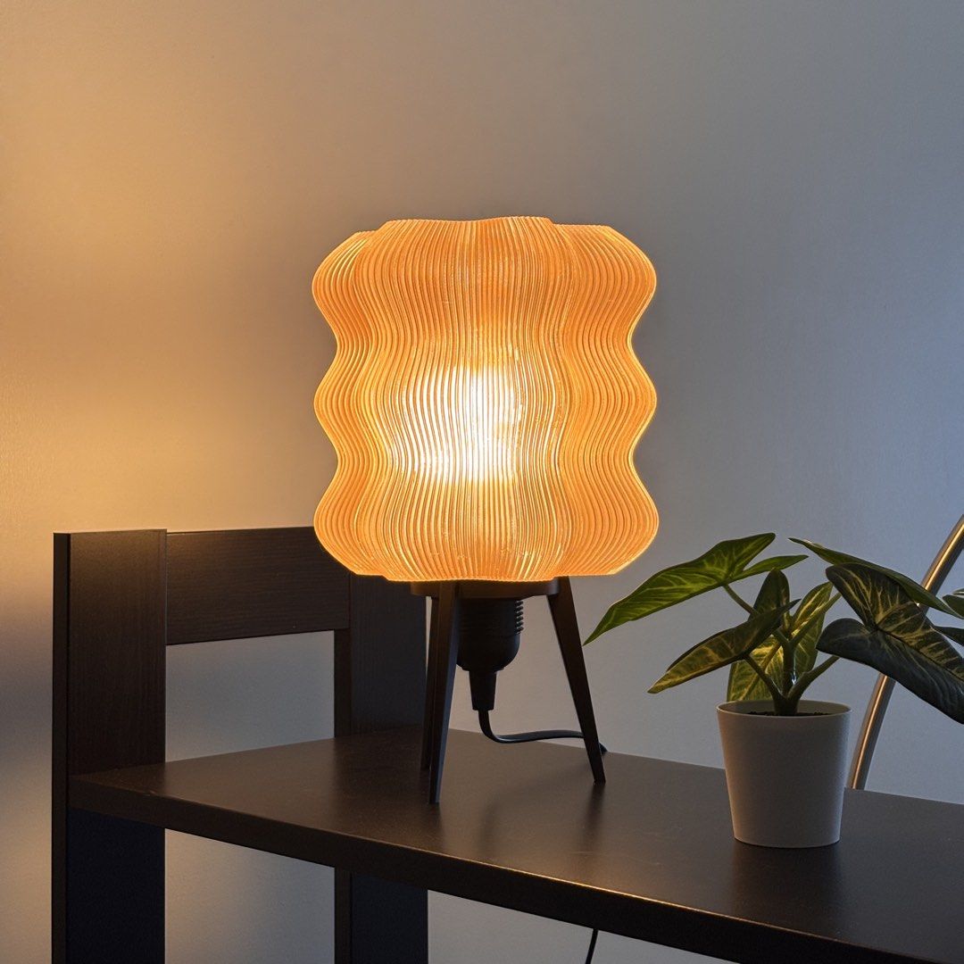 Brown Wavy Lamp (with Ikea LED bulb) (Category: Lighting) located in Mandaluyong City. Submitted by taag_ (Listing ID 1462877599, Image 2). Description: - Brand new, comes in a box and paper bag - Translucent light brown - 18cm L x 18 cm W x 28 cm H - 3D printed, please allow minimal imperfections - Comes with an Ikea E27 Solhetta LED bulb (warm light) Licensed design by Eris https://makerworld.com/@eris2000.