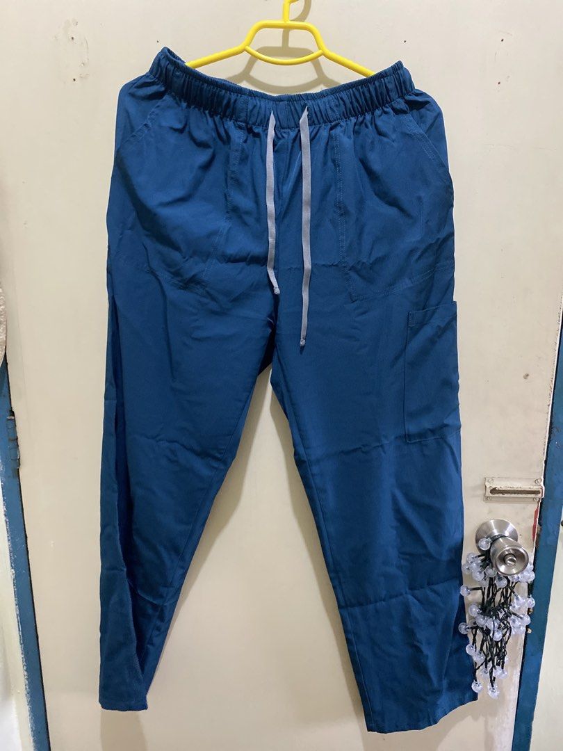 Teal Scrub Suit Top and Pants Set - Size M (Category: Sets or Coordinates) located in Pasig City. Submitted by alaineeeee (Listing ID 1462774700, Image 3). Description: - Teal scrub set (top and pants) from WENURSE - Size: Medium - Top features a V-neck and multiple pockets - Pants have an elastic waistband with a drawstring and side pockets - Comfortable and practical for everyday wear - Selling as a complete set.