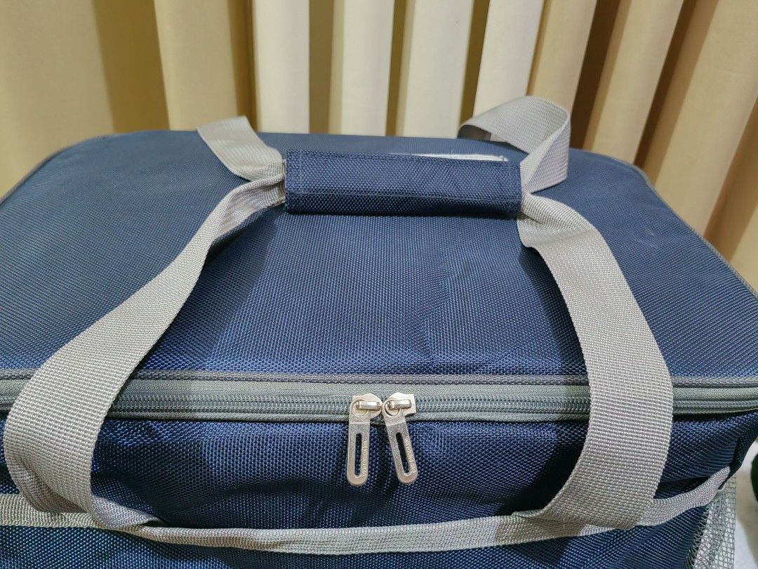 Weyoung Navy Blue Insulated Cooler Bag (Category: Food Organization & Storage) located in Makati City. Submitted by prelovedtreatedwithlove (Listing ID 1462847847, Image 3). Description: - Navy blue Weyoung cooler bag - Spacious main compartment with insulated lining - Two mesh side pockets for extra storage - Sturdy handles and zip closure - Ideal for picnics, beach trips, or keeping food cool on the go. - Big size 40x27x27cm -with strap -like n