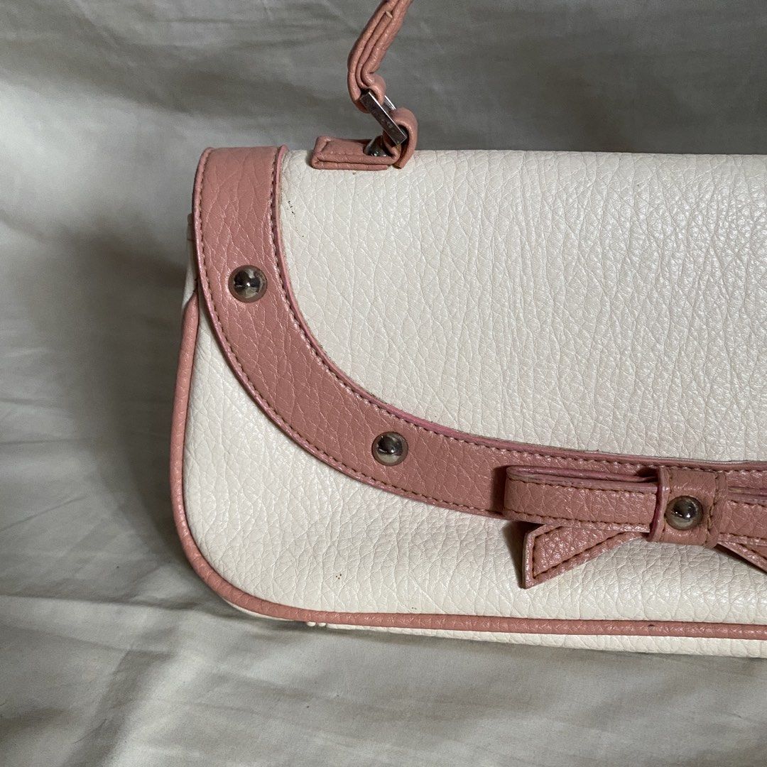 White and Pink Bow Rectangular Vintage Leather Handbag (Category: Luxury Bags & Wallets) located in Manila. Submitted by yannaapril (Listing ID 1462742842, Image 2). Description: Clean and high quality leather material, cute y2k whimsical | with free twilly - Adorable white handbag with charming pink trim and bow detail. - Features a single handle for easy carrying. - Secure flap closure to keep your belongings safe. - Compact size, ideal for ess
