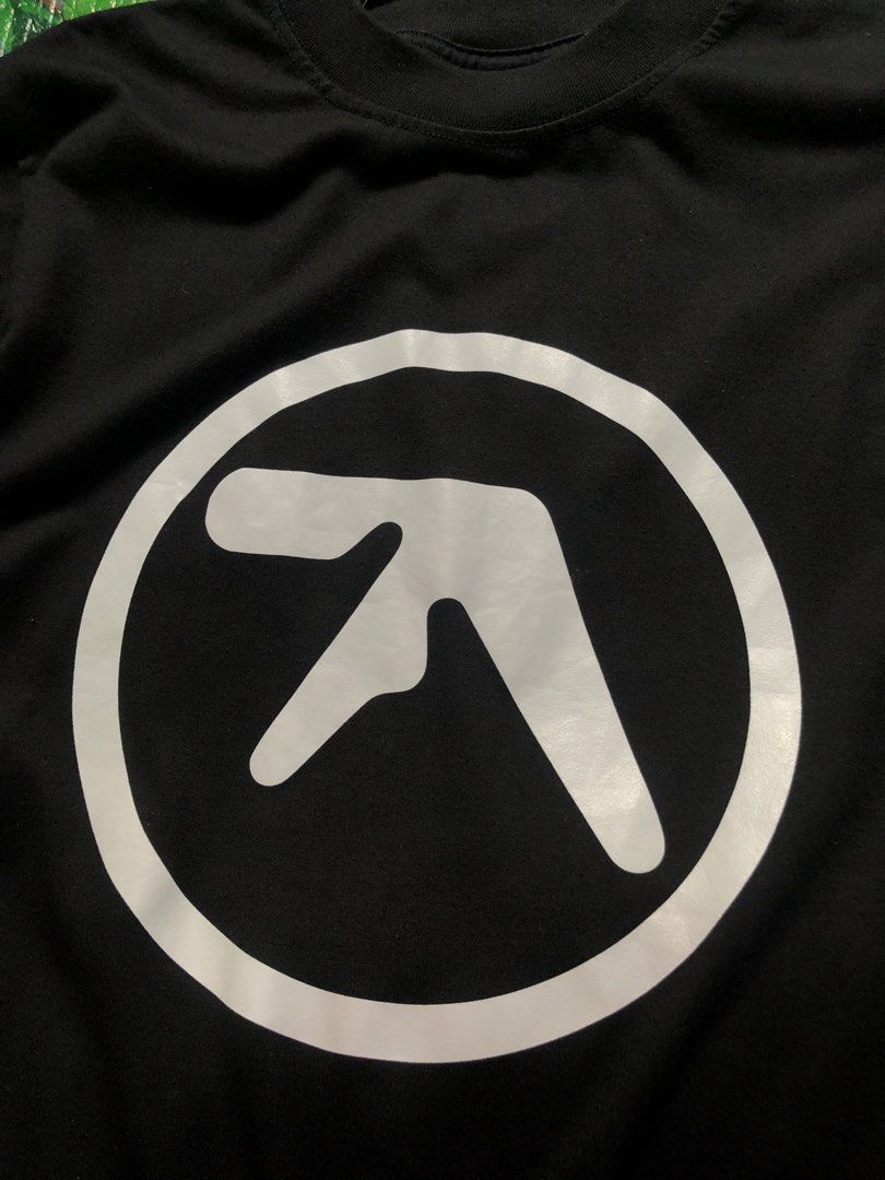 White Aphex Twin Logo (Category: Tshirts & Polo Shirts ) located in San Jose. Submitted by mightycloud-7dc0 (Listing ID 1462789261, Image 3). Description: - Iconic Aphex Twin logo t-shirt - Color: Black with white print - Style: Classic crew neck, short sleeves - Quality: Good print quality, comfortable fit - Condition: Shows minimal signs of wear - Perfect for electronic music fans.