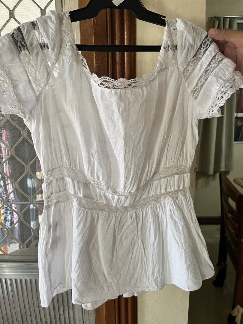 White blouse (Category: Blouses) located in Bacoor. Submitted by ayit. (Listing ID 1462719149, Image 2). Description: - White blouse - Japanese brand - Size: S (EU 36 / UK 8 / US 4) - Features delicate lace accents on sleeves and neckline - Button-down front closure.
