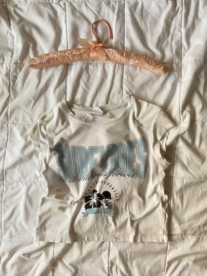 White Crop Top with 'Side Vibes' Graphic (Category: Shirts) located in Laoag. Submitted by shop.kawes (Listing ID 1462687909, Image 1). Description: - White cropped t-shirt - Features a blue 'Side Vibes' graphic - 'Palm Trees Forever' and 'Superstar Est. 1992' detailing #y2k #babytee.