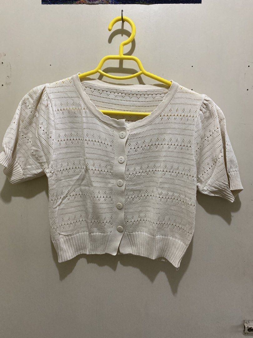 White Cropped Button-Up Knit Cardigan (Category: Coats, Jackets and Outerwear) located in Pasig City. Submitted by alaineeeee (Listing ID 1462772849, Image 1). Description: - Cute white cropped cardigan - Short sleeves with puff detail - Button-up front - Open knit pattern all over - Ribbed hem - Versatile: great for layering or wearing on its own.