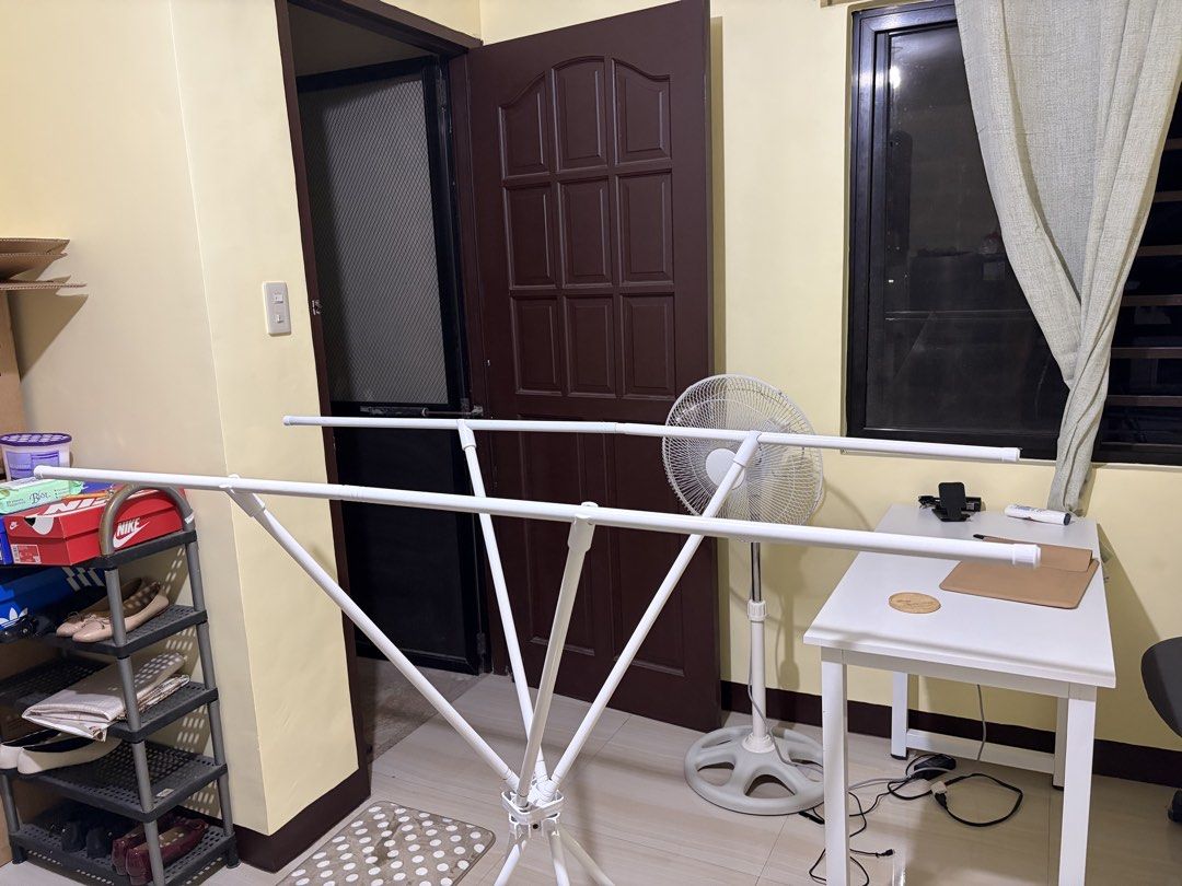 White Foldable Drying Rack for Clothes (Category: Clothes Drying Rack) located in Makati City. Submitted by ria_cat (Listing ID 1462868519, Image 2). Description: - White foldable drying rack - Multiple bars for hanging clothes - Ideal for indoor or outdoor laundry drying - Simple to set up and store away - Sturdy and reliable design.