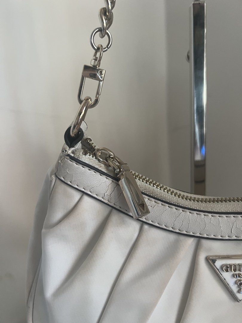 White GUESS Ruched Shoulder Bag (Category: Shoulder Bags) located in Bulacan. Submitted by shopwithaaz (Listing ID 1462765733, Image 3). Description: - GUESS white ruched shoulder bag - Silver chain strap - heart charm NOT included - Secure zipper closure - Minor marks on fabric (please check photos for details) - Ideal for casual outings and everyday use.