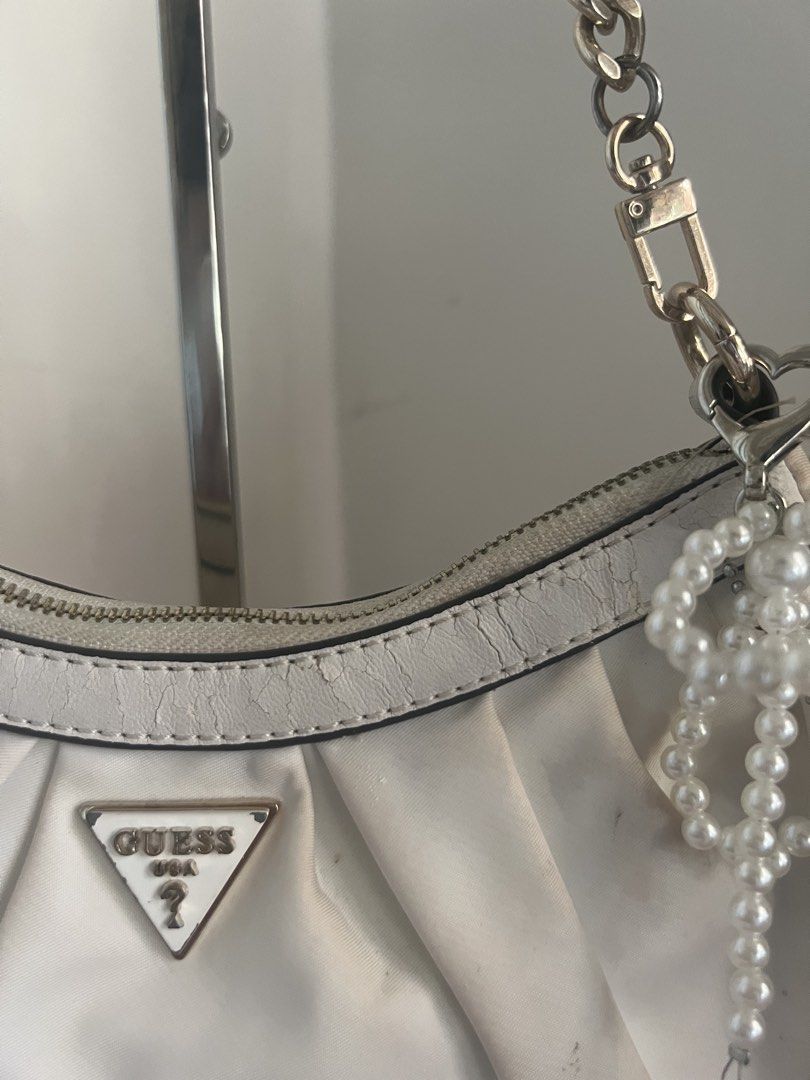White GUESS Ruched Shoulder Bag (Category: Shoulder Bags) located in Bulacan. Submitted by shopwithaaz (Listing ID 1462765733, Image 2). Description: - GUESS white ruched shoulder bag - Silver chain strap - heart charm NOT included - Secure zipper closure - Minor marks on fabric (please check photos for details) - Ideal for casual outings and everyday use.