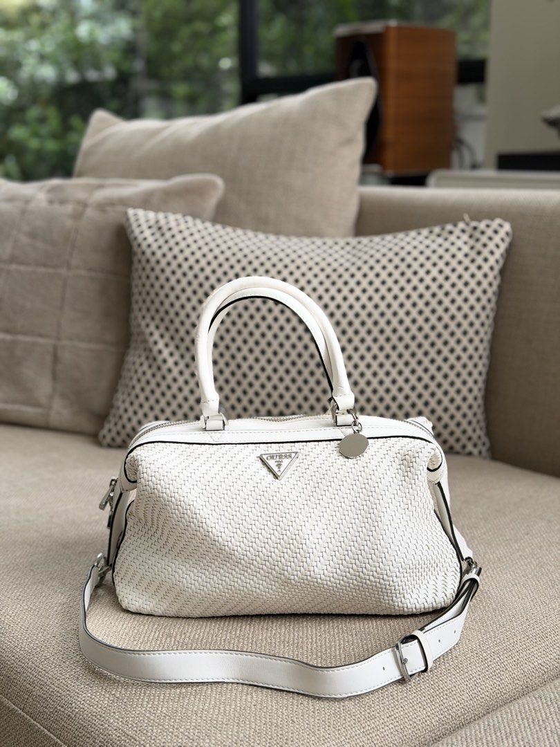 White Guess Woven Satchel Bag (Category: Luxury Bags & Wallets) located in Las Pinas. Submitted by cawyl (Listing ID 1462826403, Image 1). Description: - Guess white woven satchel bag - Top handles and detachable crossbody strap - Silver hardware with Guess charm - Spacious interior - Ideal for everyday use.