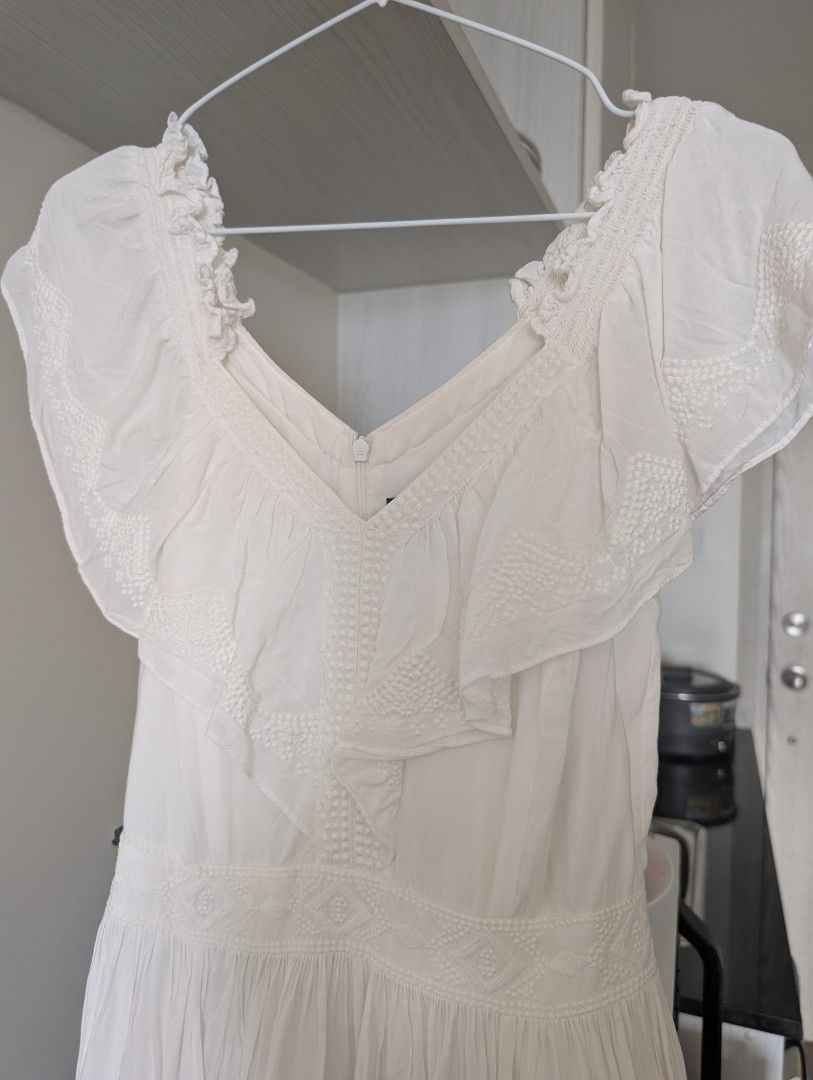 White Mini Dress (Category: Dresses) located in Quezon City. Submitted by the4thstar.store (Listing ID 1462723216, Image 3). Description: - Brand: ONLY Edge Luxury - Color: White - Size: XS - Design: Ruffled off-shoulder - Details: Lace trim on neckline and sleeves - Closure: Back zipper - Occasion: Perfect for summer days or casual events.