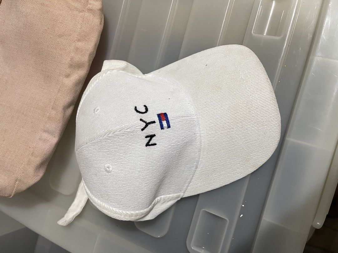 White NYC Cap with Flag Detail (Category: Caps & Hats) located in Paranaque City. Submitted by alexagamboa (Listing ID 1462827542, Image 1). Description: - White baseball cap with 'NYC' embroidery - Small flag detail next to lettering - Simple and classic design - Ideal for casual wear and streetwear - Adjustable strap at the back for a comfortable fit.