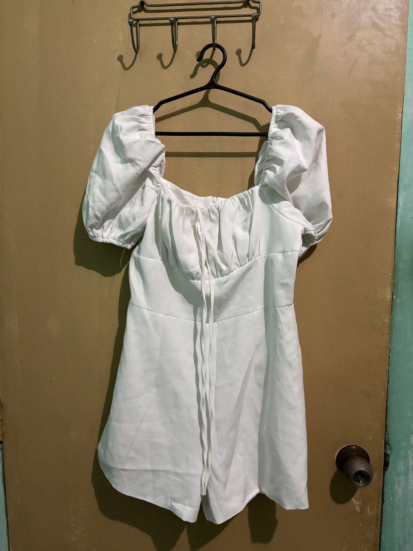 White Puff Sleeve Square Neck Romper (Category: Rompers) located in Manila. Submitted by vastmountain_7ec616 (Listing ID 1462688471, Image 1). Description: - Adorable white romper with charming puff sleeves. - Elegant square neckline with a tie detail. - Convenient zipper closure at the back. - Flattering cut on the shorts for a great silhouette. - Ideal for casual outings or a beach getaway. - Versatile styling with sandals or sneakers..