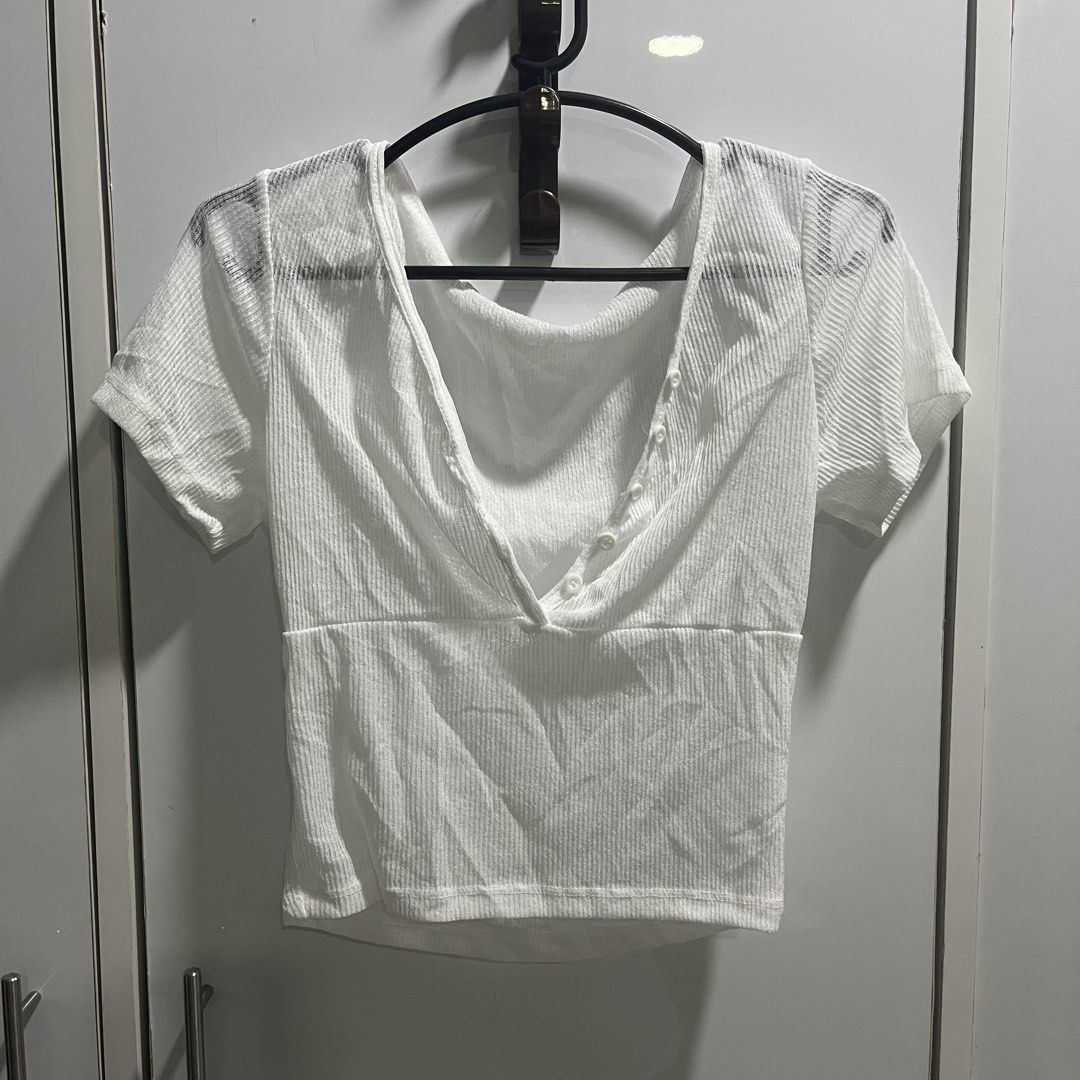 White Ribbed V-Neck Button Up Crop Top Cover Up (Category: Sleeveless) located in Manila. Submitted by 4ngeluh (Listing ID 1462684127, Image 1). Description: - White ribbed crop top - V-neckline with button details - Short sleeves - Stretchy material for a comfortable fit - Versatile: pairs well with high-waisted jeans or skirts - Easy to dress up or down for any occasion - SWIMSUIT COVER UP.
