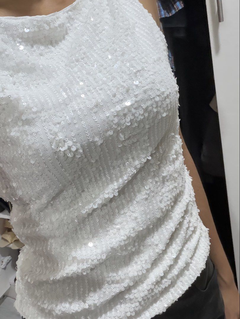White Sequin Sleeveless Tank Top (Category: Sleeveless) located in Pasig City. Submitted by miss_abuelita (Listing ID 1462780353, Image 3). Description: - White sequin tank top - Sleeveless with scoop neckline - All-over sequins on front and back - Fitted style - Versatile: dress up or down - Pairs well with jeans, skirts, or black pants.