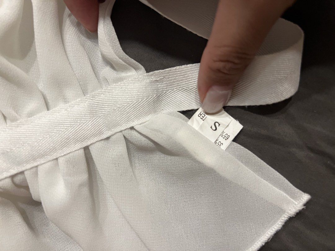 White Sheer Halter Neck Top with Ruffles (Category: Sleeveless) located in Paranaque City. Submitted by dubaichocolei (Listing ID 1462739911, Image 3). Description: - White sheer halter neck top - Features ruffles along hem and bust - Ties at back and neck for adjustable fit - Lightweight and flowy material - Perfect for layering or wearing solo.