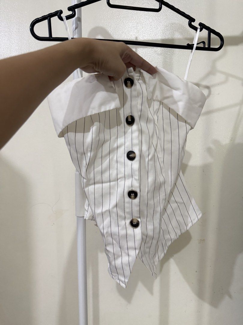 White Striped Off-Shoulder Button-Up Top (Category: Blouses) located in Manila. Submitted by lovedbyan (Listing ID 1462878366, Image 1). Description: -XS-M - White top with subtle black pinstripes - Trendy off-shoulder design - Classic collar detail - Functional button-up front with dark buttons - Delicate thin white straps - Vest-like silhouette - Perfect for both casual and dressed-up looks.