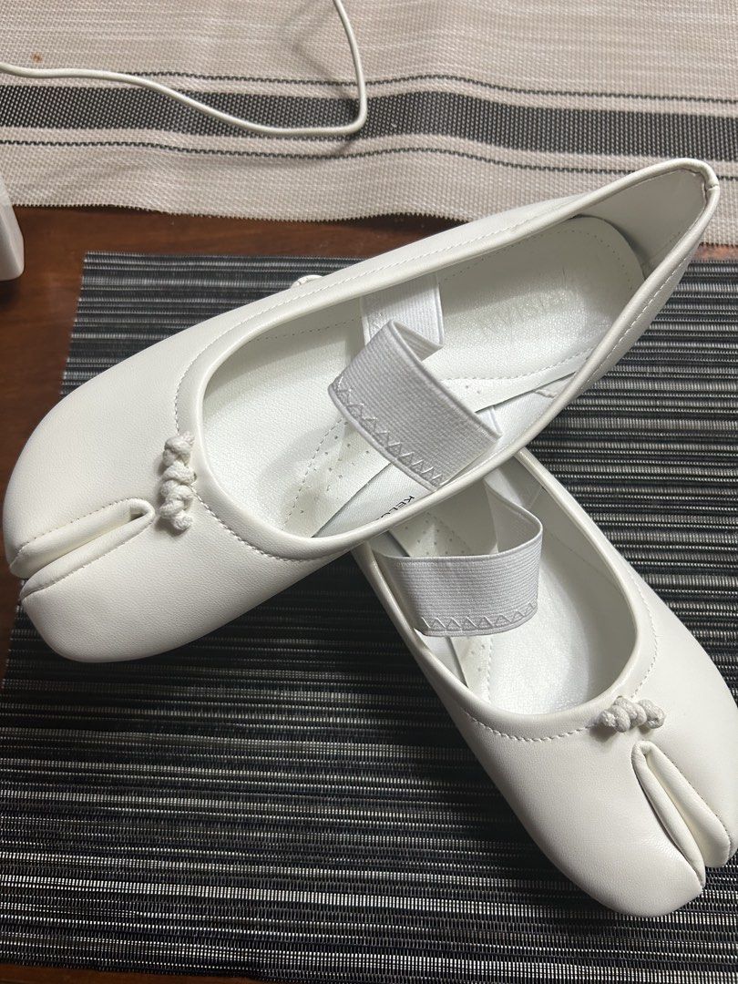 White Tabi Split Toe Ballet Flats with Elastic Strap (Category: Flats & Sandals) located in Manila. Submitted by dubichachi (Listing ID 1462735748, Image 3). Description: - White tabi flats with a unique split toe design. - Elastic strap across the instep ensures a secure and comfortable fit. - Simple and clean aesthetic, versatile for any outfit. - Textured sole provides excellent grip for everyday wear. - Marked as Size 7 on the sole..