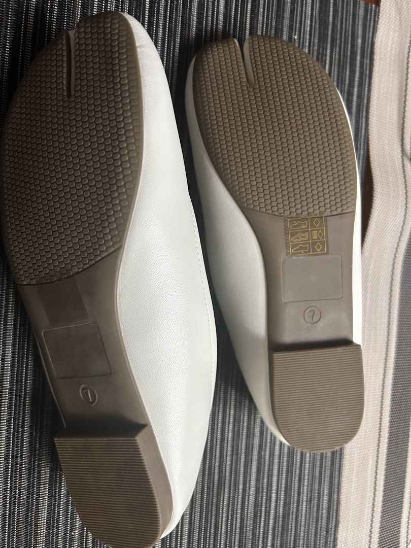 White Tabi Split Toe Ballet Flats with Elastic Strap (Category: Flats & Sandals) located in Manila. Submitted by dubichachi (Listing ID 1462735748, Image 2). Description: - White tabi flats with a unique split toe design. - Elastic strap across the instep ensures a secure and comfortable fit. - Simple and clean aesthetic, versatile for any outfit. - Textured sole provides excellent grip for everyday wear. - Marked as Size 7 on the sole..