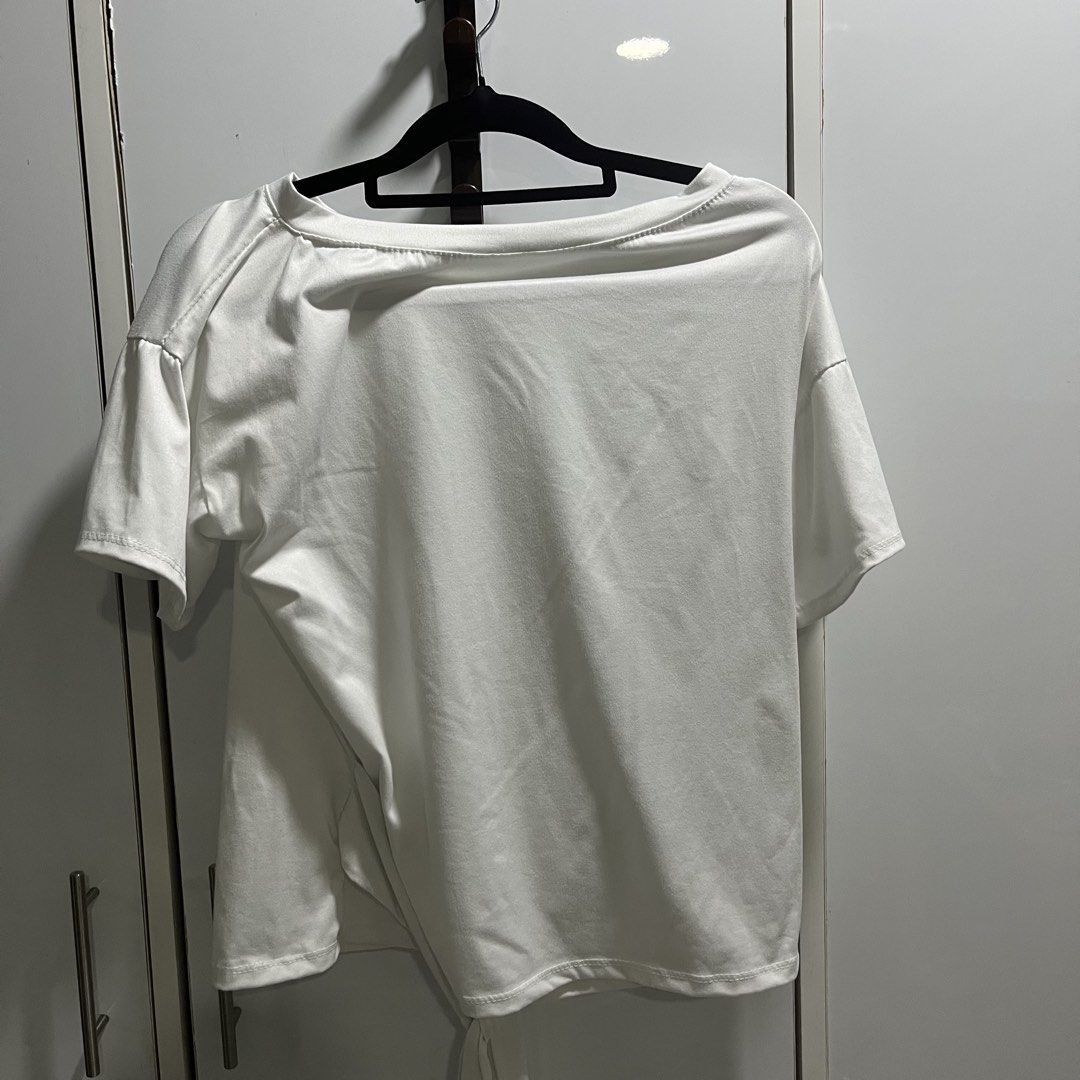 White Tie-Back T-Shirt Off-Shoulder Top (Category: Shirts) located in Manila. Submitted by 4ngeluh (Listing ID 1462682643, Image 3). Description: - Soft and flowy white t-shirt - Unique tie-back detail - Can be worn off-shoulder for a casual vibe - Short sleeves - Versatile for everyday wear or layering - Easily pairs with jeans or skirts.